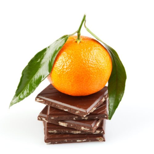 Fresh tangerine over chocolate blocks . Isolated on white.